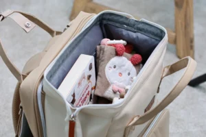 Geöffneter LIINI Wickelrucksack mit Windeln, Spielzeug und Babysachen